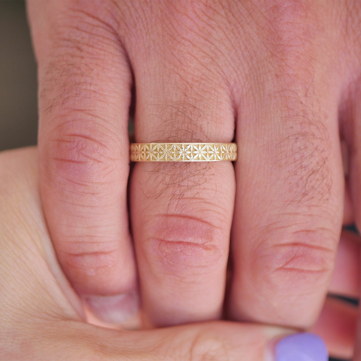 man wearing vintage inspired 14k yellow gold antique star wedding band