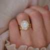 Woman wearing deco diamond engagement ring with stacked dotted weddings bands.