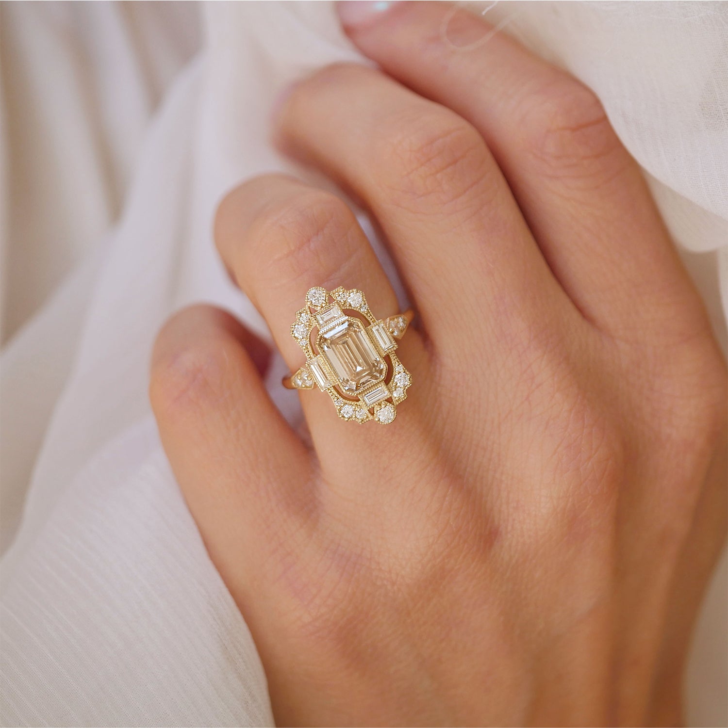 woman wearing unique and one of a kind engagement ring with champagne center diamond and diamond mosaic ring