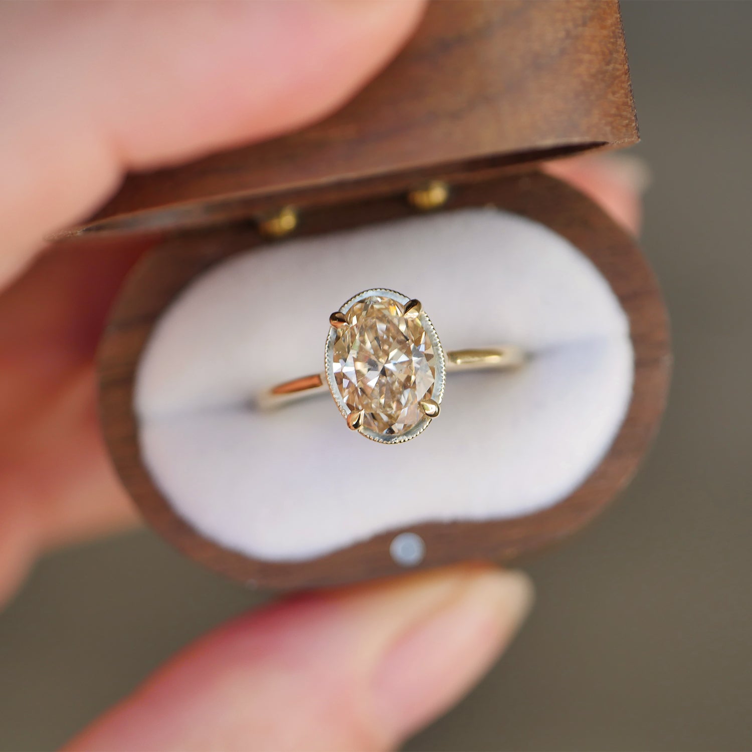 vintage wooden box with champagne oval shaped diamond solitaire