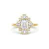 A deco moissanite and diamond engagement ring set in 14k yellow gold.
