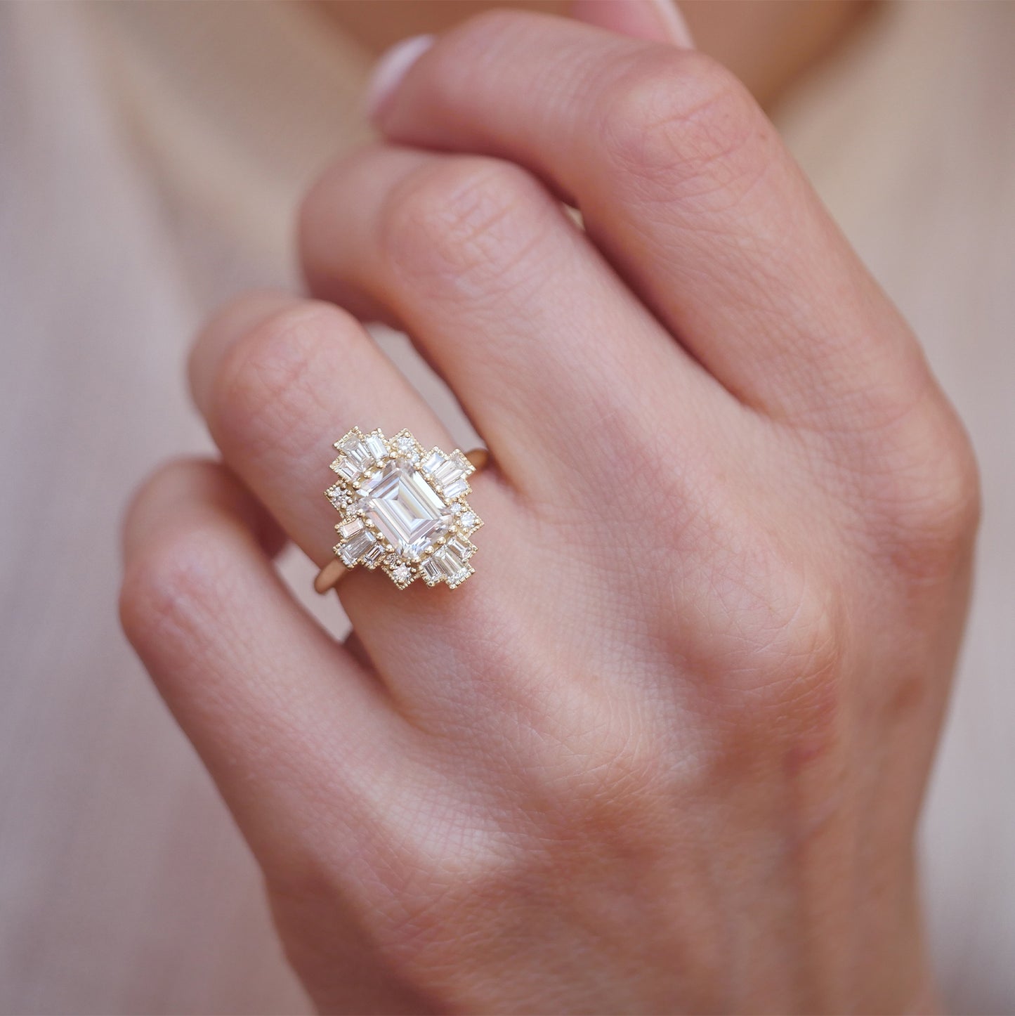 woman wearing unique 14k yellow gold deco moissanite and diamond engagement ring perfect for stacking