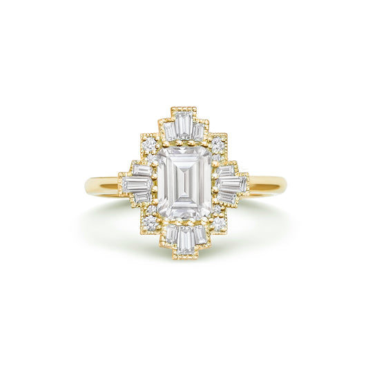 A deco moissanite and diamond engagement ring set in 14k yellow gold.