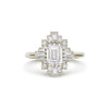 A deco moissanite and diamond engagement ring set in 14k white gold.