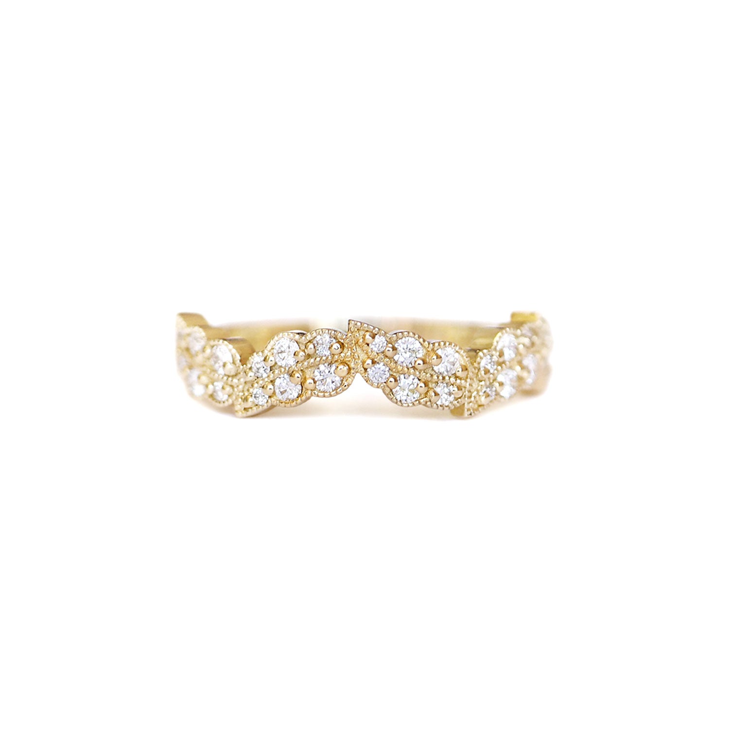 A leaf inspired ring with a series of round brilliant cut diamonds set in 14k yellow gold.
