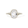 An elongated antique cushion cut solitaire ring with a lab-grown diamond and milgrain detailing on a white gold band.