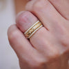 Close-up engraved star band with two pave diamond rings