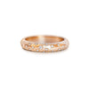 14k rose gold ring with embedded diamonds on a star-engraved band