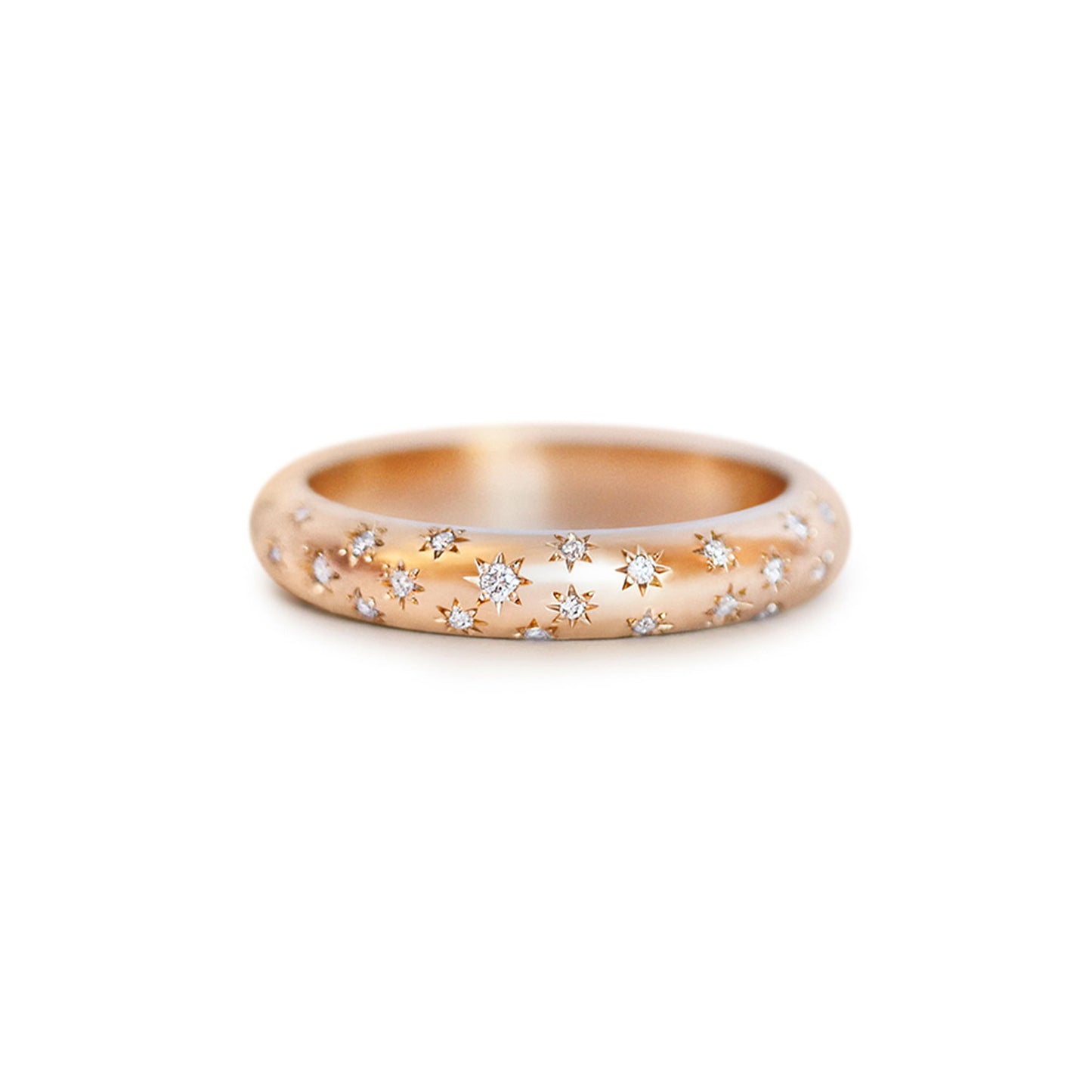 14k rose gold ring with embedded diamonds on a star-engraved band