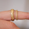 2mm and 5mm side by side 14k yellow gold wind-engraved wedding bands.