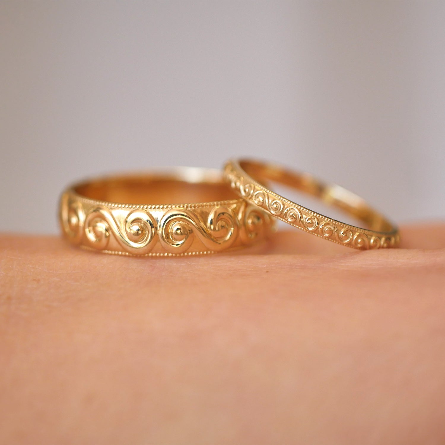 14k yellow gold wide and delicate spiral and wind wedding bands