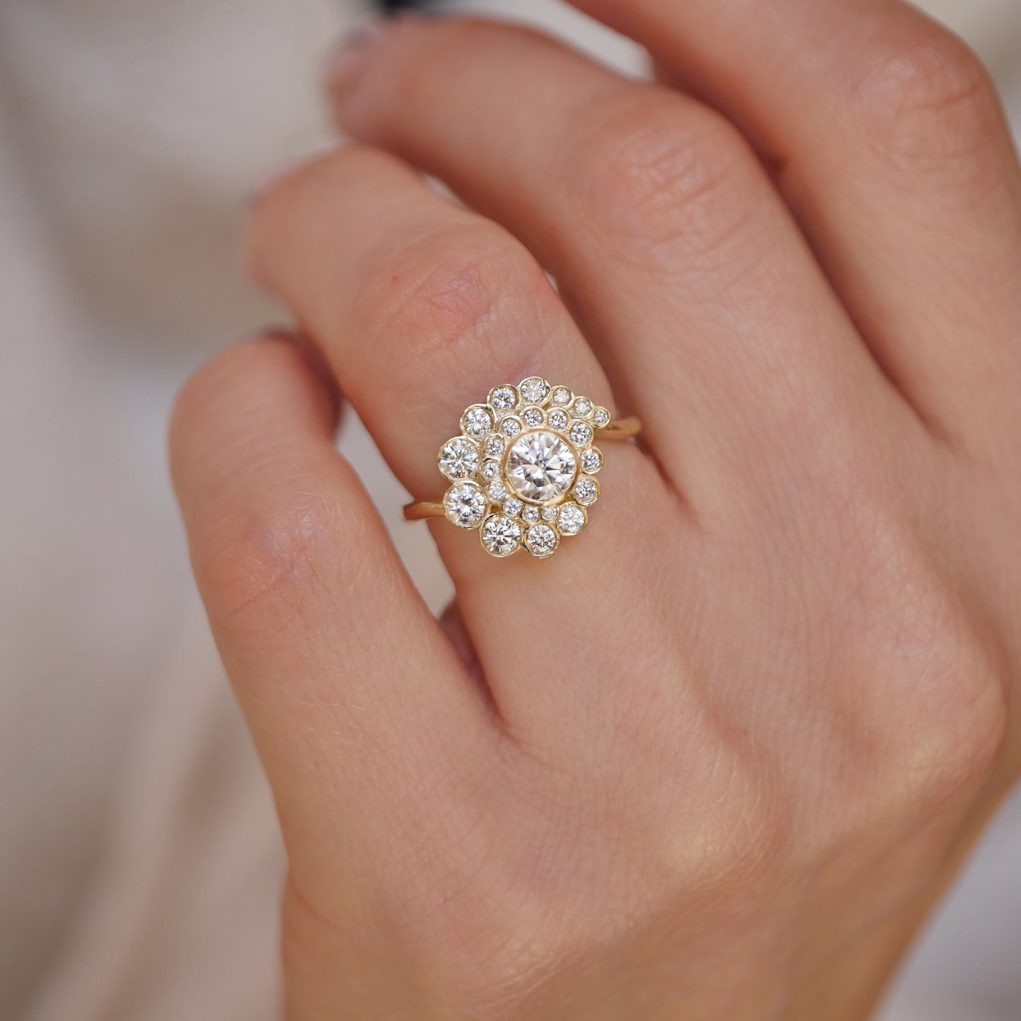 woman wearing vintage inspired engagement ring with lab diamonds in a spiral design