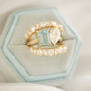 The Aquamarine & Pear Diamond Toi et Moi Ring offers a unique and romantic design, where the serene aquamarine and the radiant pear diamond come together to represent the union of two hearts. Stacked with two diamond confetti wedding bands.