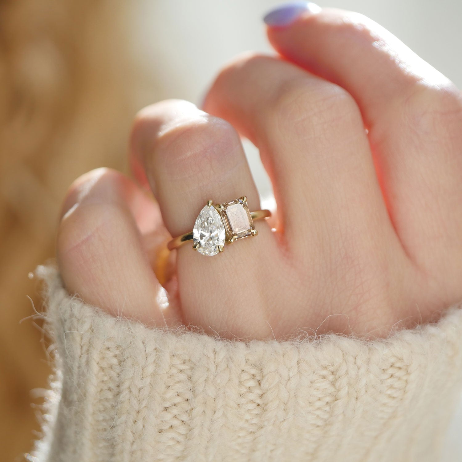 The contrasting yet complementary pear diamond and champagne emerald are beautifully set side by side, making this ring a bold symbol of two distinct yet harmonious personalities.
