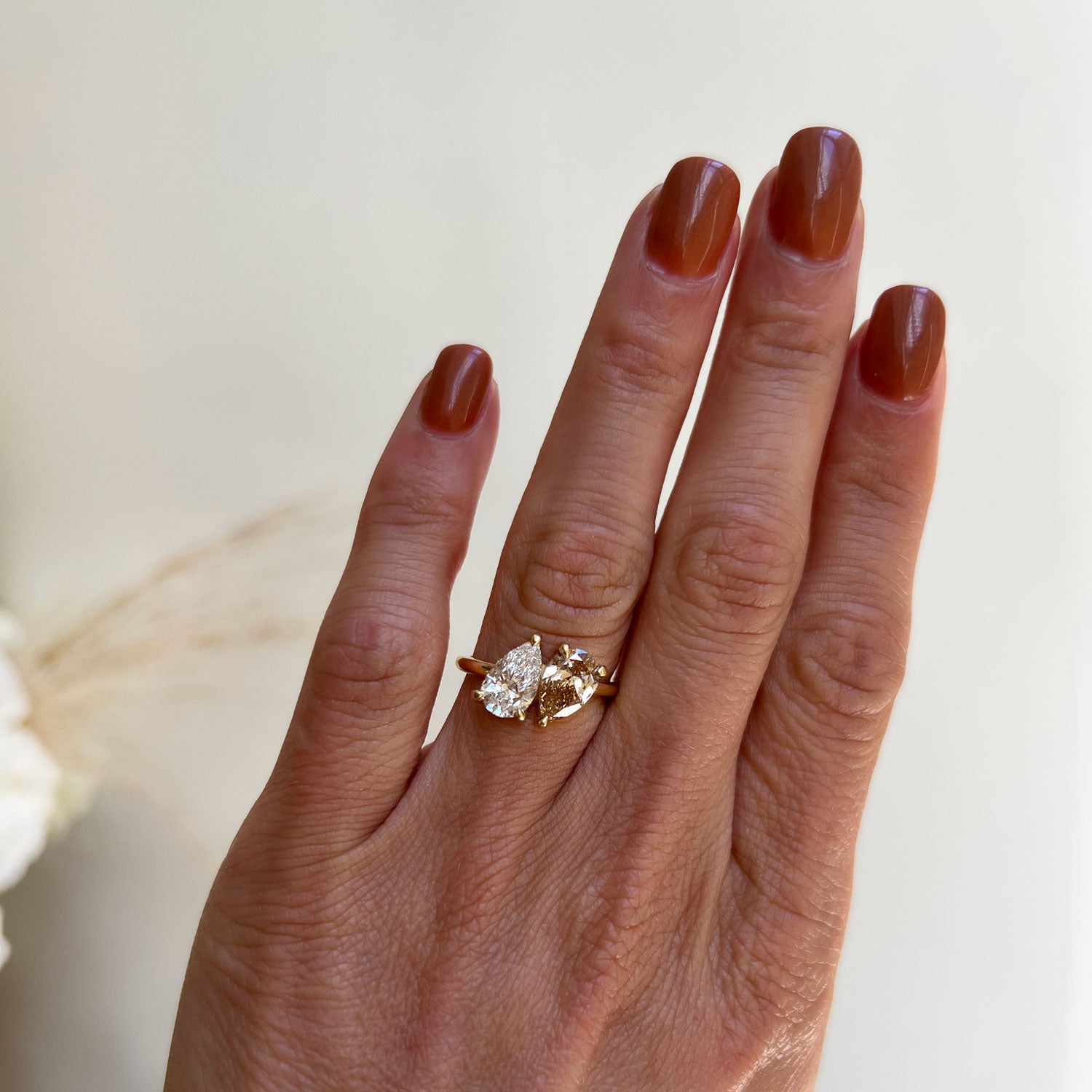 The rich, warm tone of the champagne pear diamond in this toi et moi ring creates a luxurious and romantic look, perfect for those seeking a unique twist on a classic symbol of love.