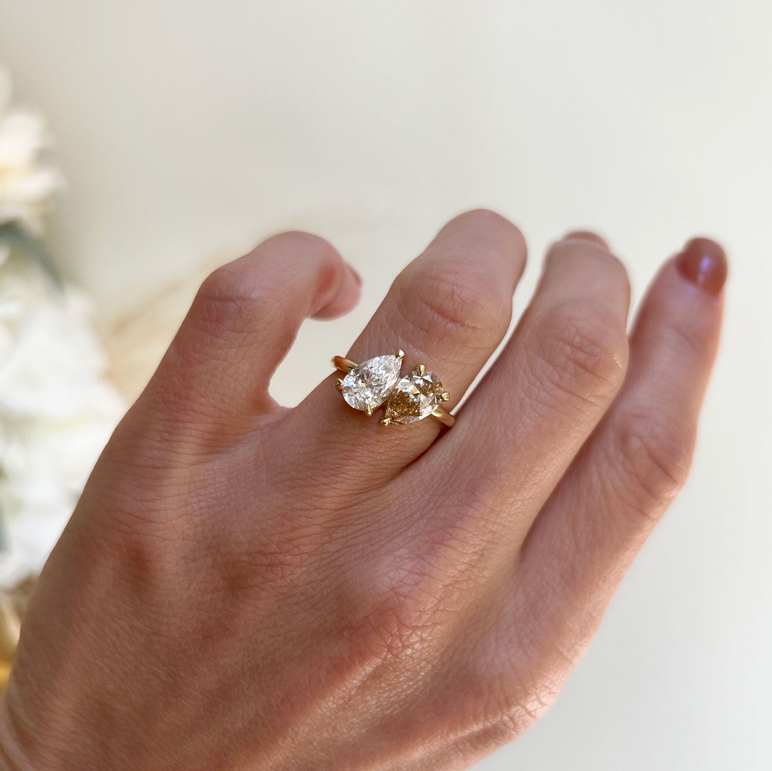 This ring features a mesmerizing pear-shaped champagne diamond, exuding warmth and elegance, making it a perfect symbol of two souls intertwined in love and harmony.